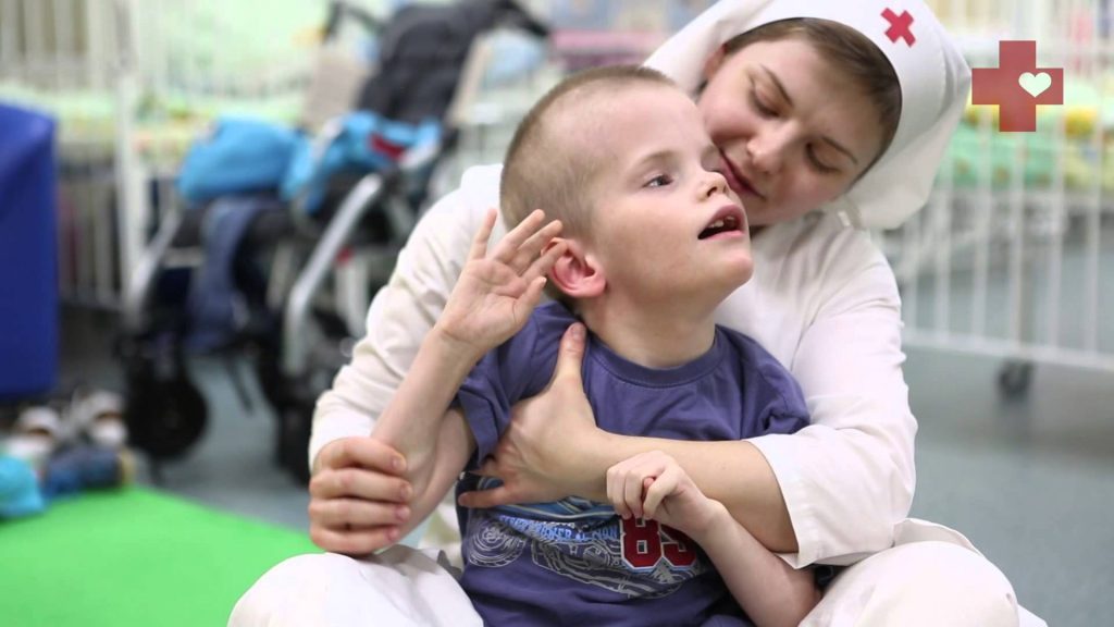 Sister Of Mercy Takes Care Of A Disabled Child